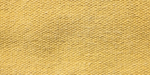 Texture of soft yellow fabric as background, top view