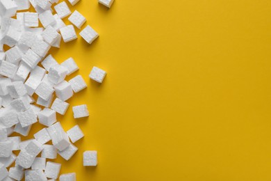 Many styrofoam cubes on yellow background, flat lay. Space for text