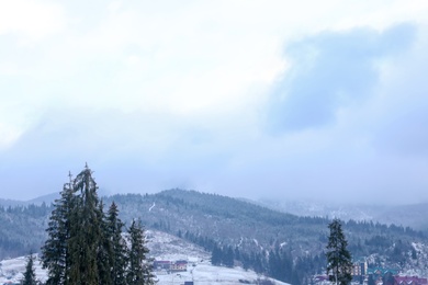 Photo of Beautiful view of small town in snowy valley. Winter vacation