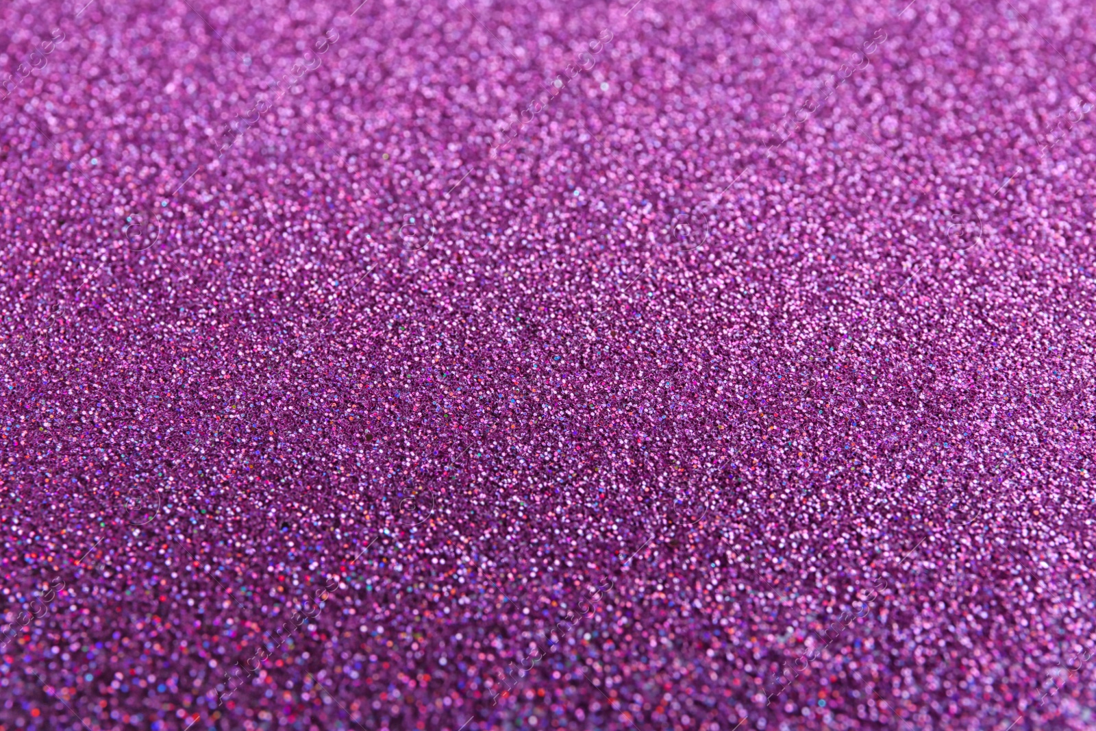 Photo of Closeup view of sparkling violet glitter background