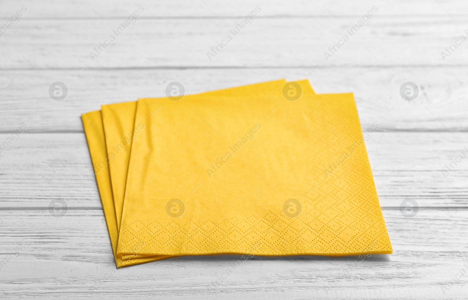 Photo of Clean napkins on wooden background. Personal hygiene