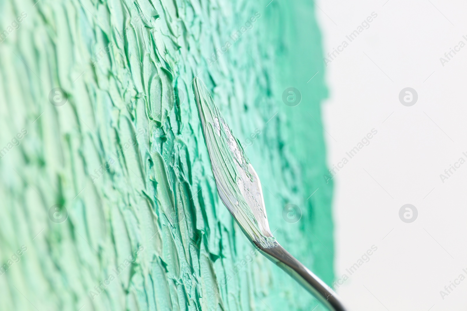 Photo of Abstract colorful artwork painting with spatula, closeup view