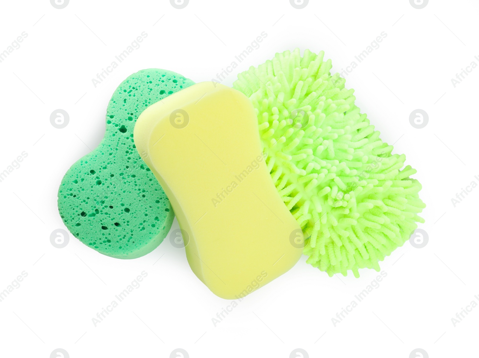 Photo of Sponges and car wash mitt on white background, top view