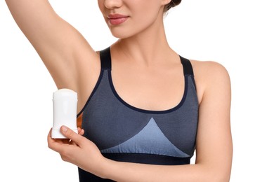 Woman applying deodorant on white background, closeup