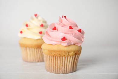 Photo of Tasty sweet cupcake on white table. Happy Valentine's Day