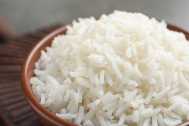 Bowl of tasty cooked white rice on table, closeup