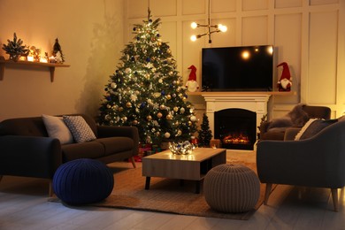 Photo of Cozy living room interior with beautiful Christmas tree near fireplace