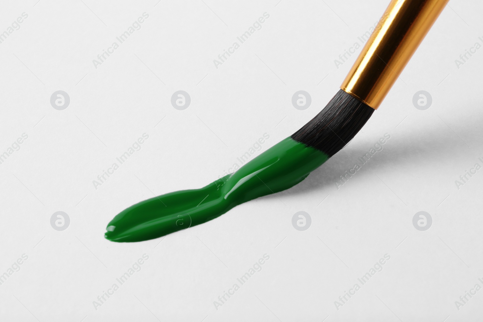 Photo of Brush with color paint and stroke on white background