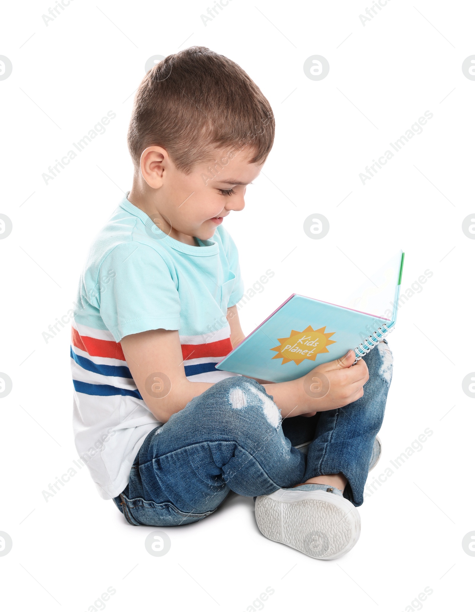 Photo of Cute little boy reading book on white background