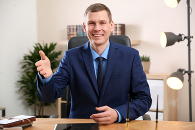 Photo of Man using video chat in office, view from web camera