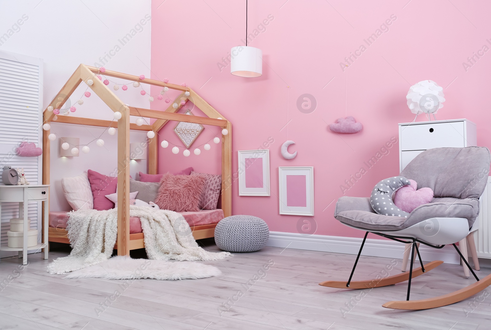 Photo of Child's room interior with comfortable bed and garland