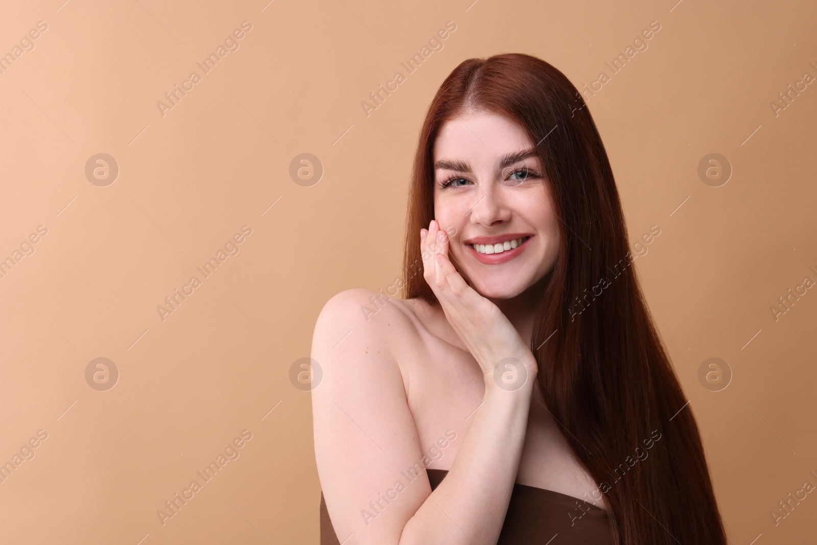 Photo of Portrait of smiling woman on beige background. Space for text