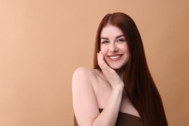 Photo of Portrait of smiling woman on beige background. Space for text