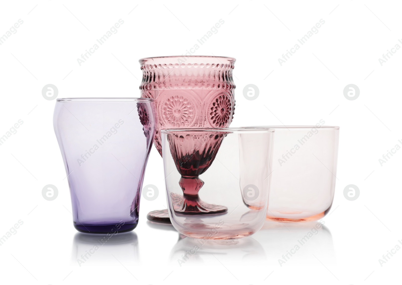 Photo of Set of colorful empty glasses on white background