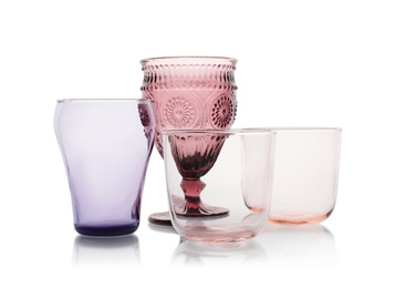 Set of colorful empty glasses on white background