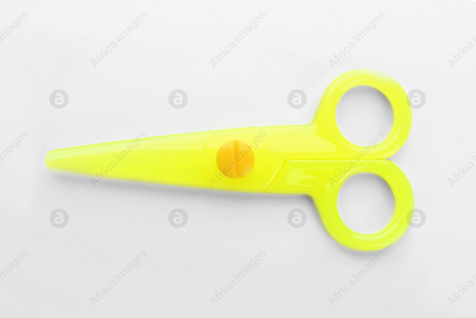 Photo of Colorful plastic scissors on white background. School stationery