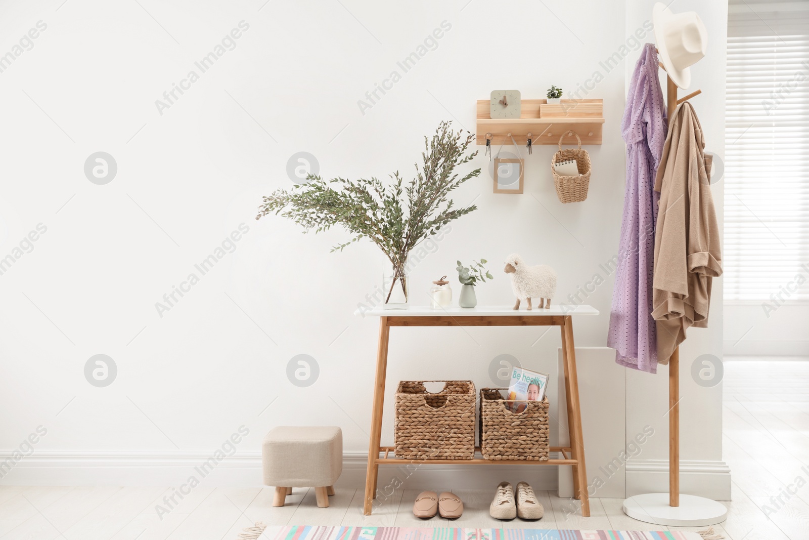 Photo of Modern hallway interior with table, clothes rack and key holder