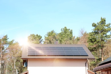 House with installed solar panels on roof. Alternative energy