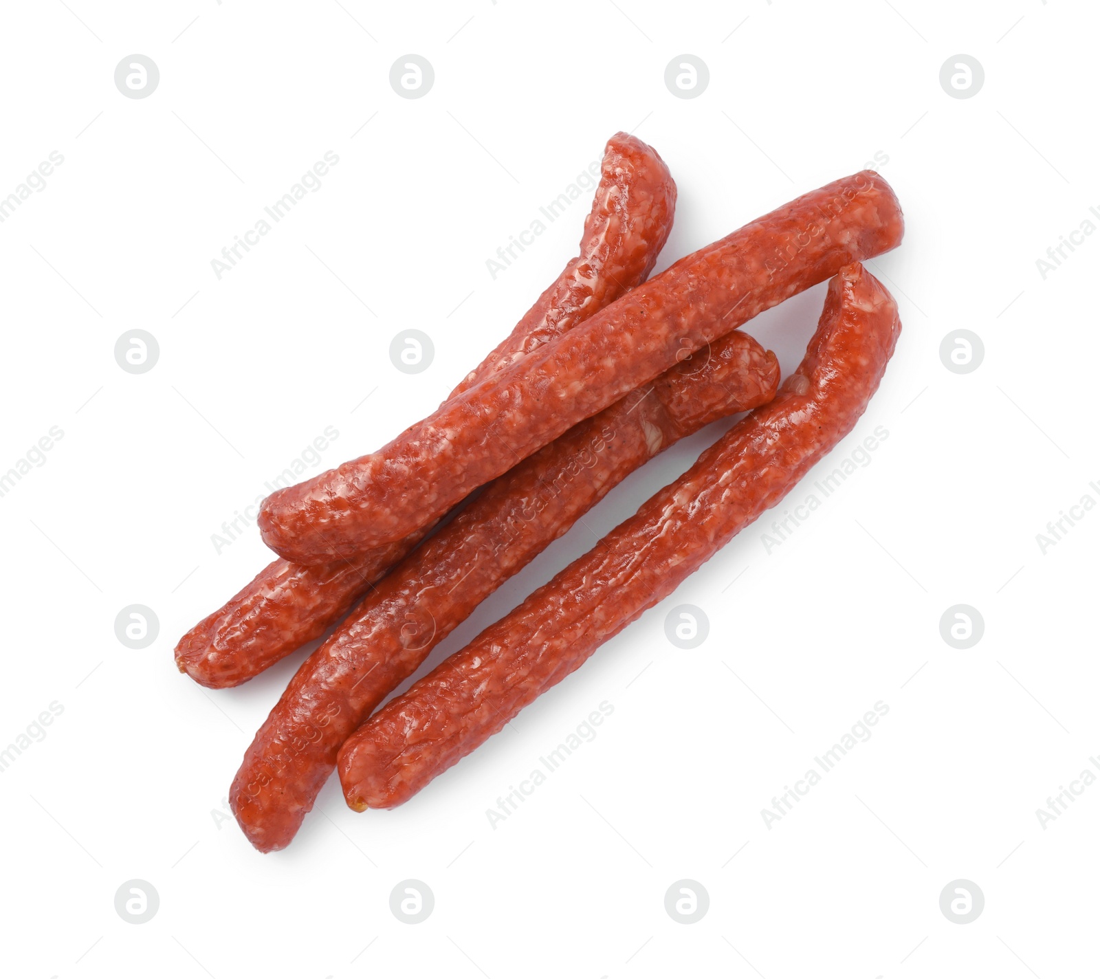 Photo of Thin dry smoked sausages isolated on white, top view