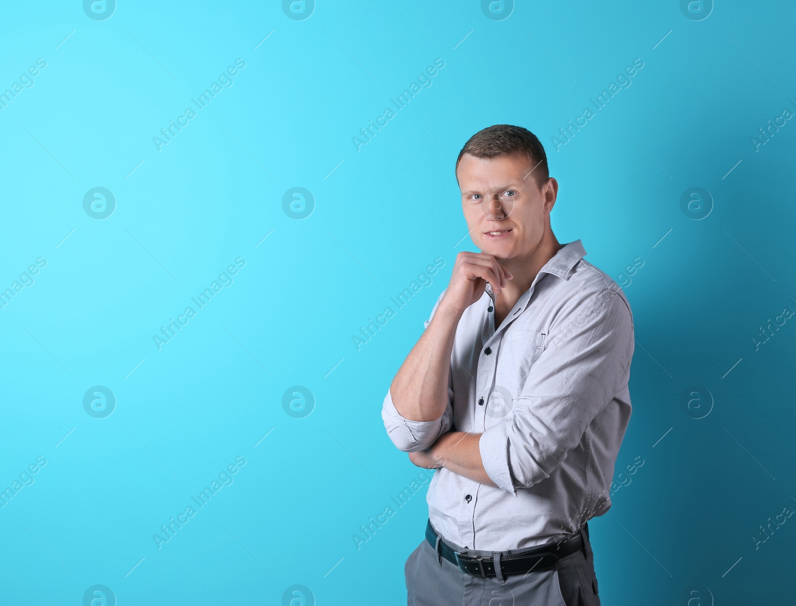 Photo of Thoughtful handsome young man on color background