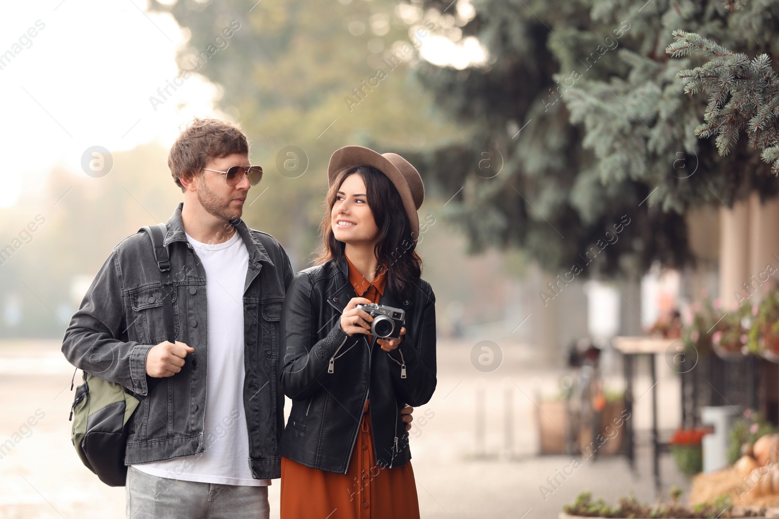 Photo of Couple of travelers with camera on city street