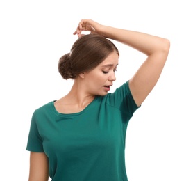 Young woman with sweat stain on her clothes against white background. Using deodorant