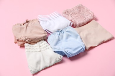 Photo of Stylish folded women's underwear on pink background