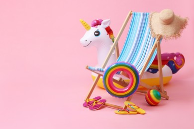 Photo of Deck chair, flip flops and other beach accessories on pink background, space for text. Summer vacation