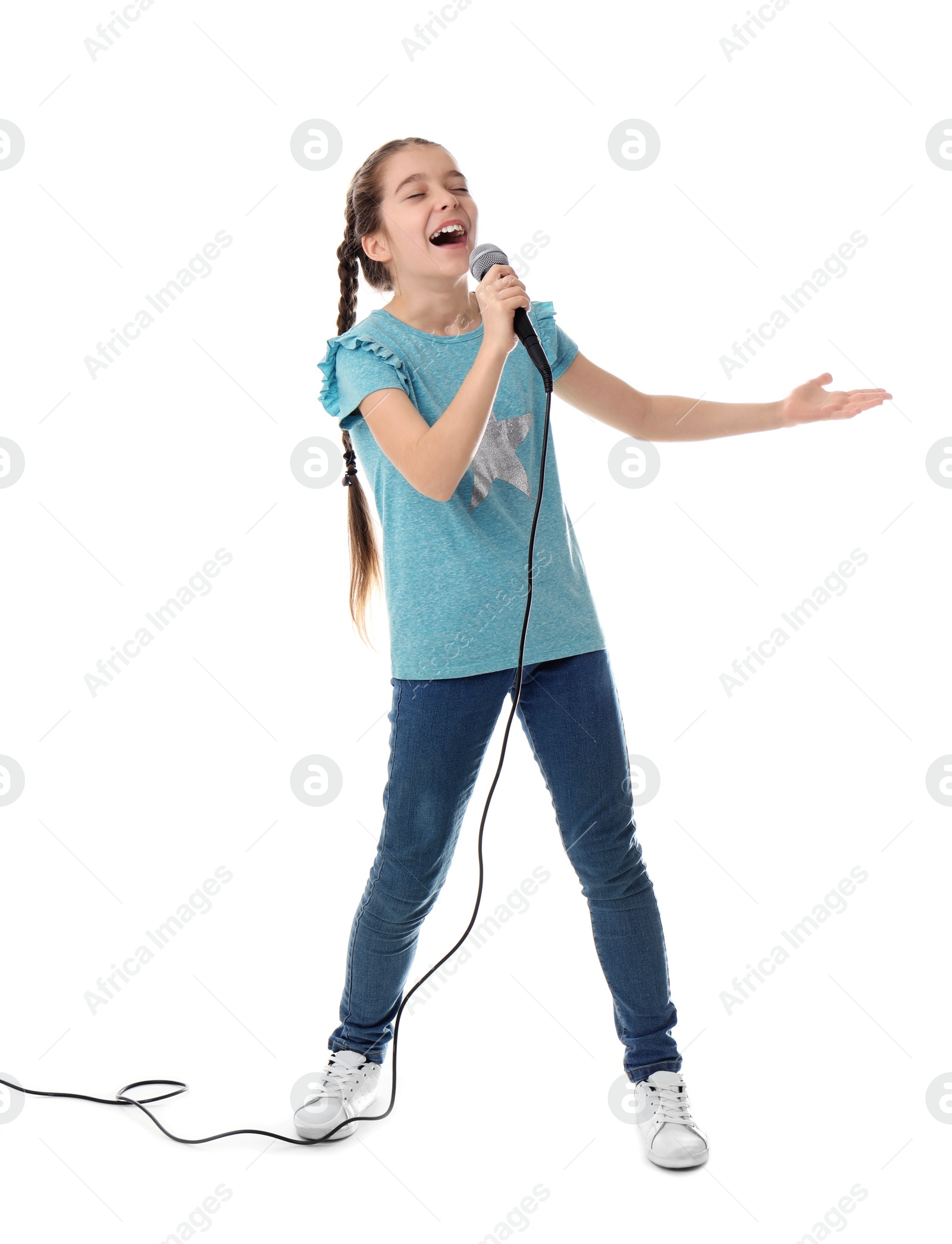 Photo of Cute girl singing in microphone on white background