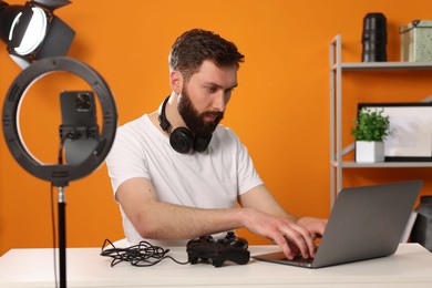 Photo of Technology blogger responding comments while recording video at home