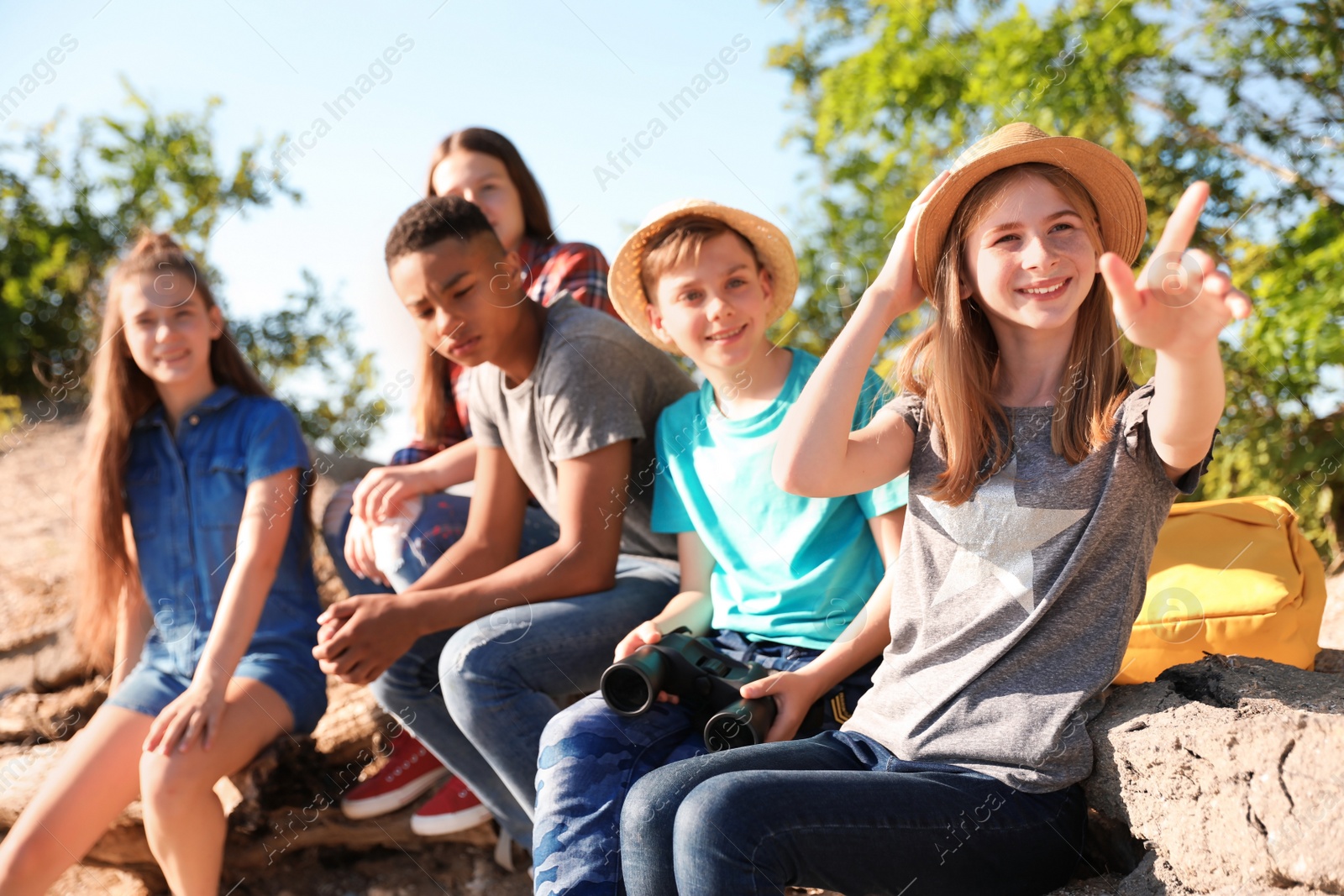 Photo of Group of children with binoculars outdoors. Summer camp