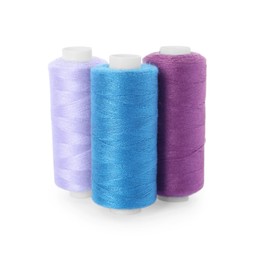 Photo of Different colorful sewing threads on white background