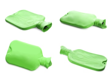 Set with green rubber hot water bottles on white background