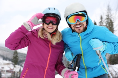 Couple of skiers on slope at resort. Winter vacation