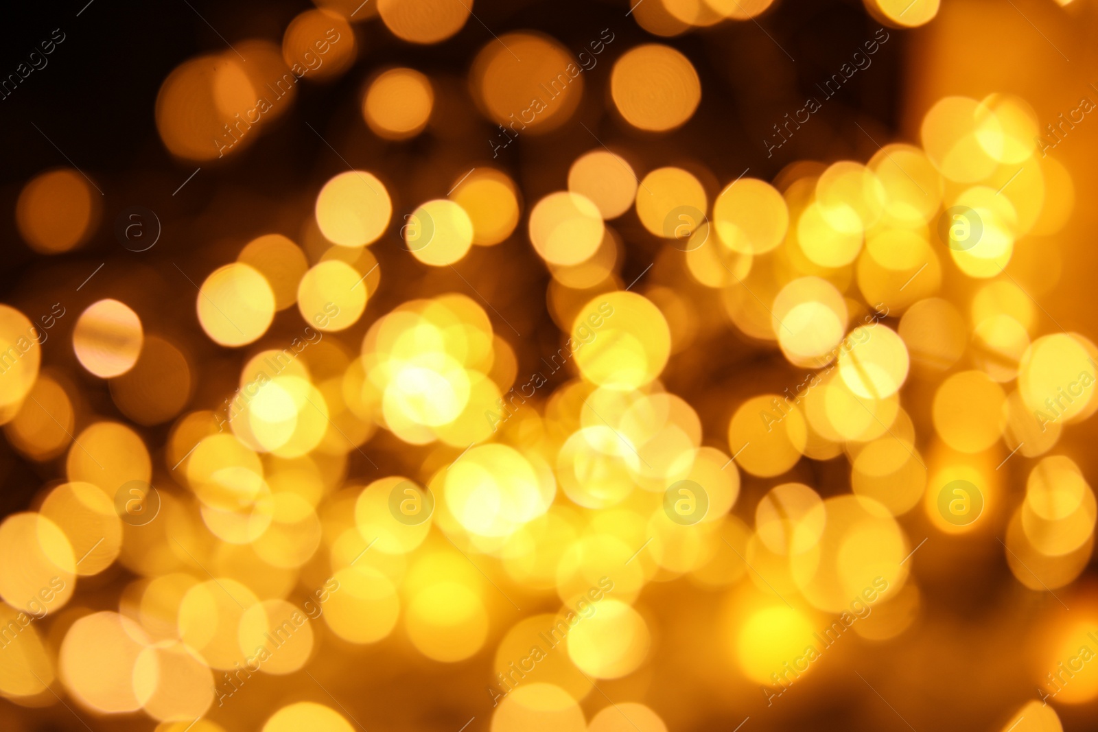 Photo of Gold glitter with bokeh effect on dark background