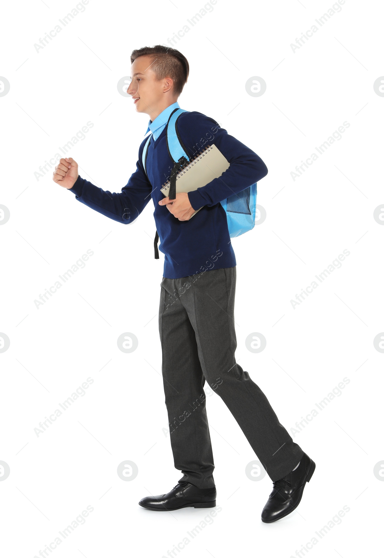 Photo of Teenage boy in stylish school uniform on white background