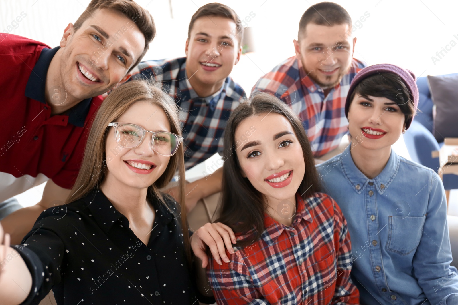 Photo of Happy friends taking selfie indoors