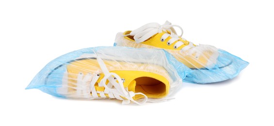 Photo of Sneakers in blue shoe covers isolated on white