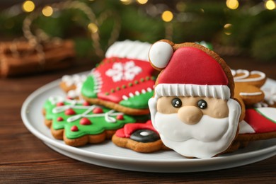 Photo of Tasty Christmas cookie in shape of Santa Claus on wooden table, closeup. Space for text