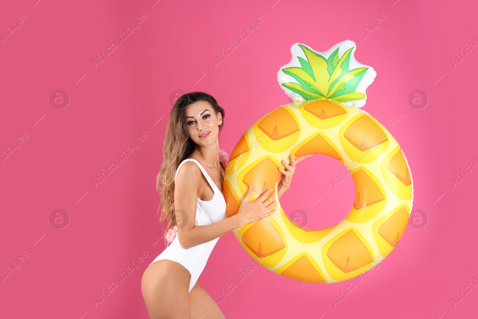 Photo of Pretty sexy woman in stylish bikini with inflatable ring on color background