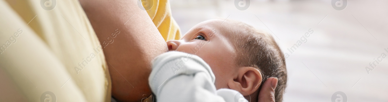 Image of Young woman breast feeding her little baby at home, closeup. Banner design