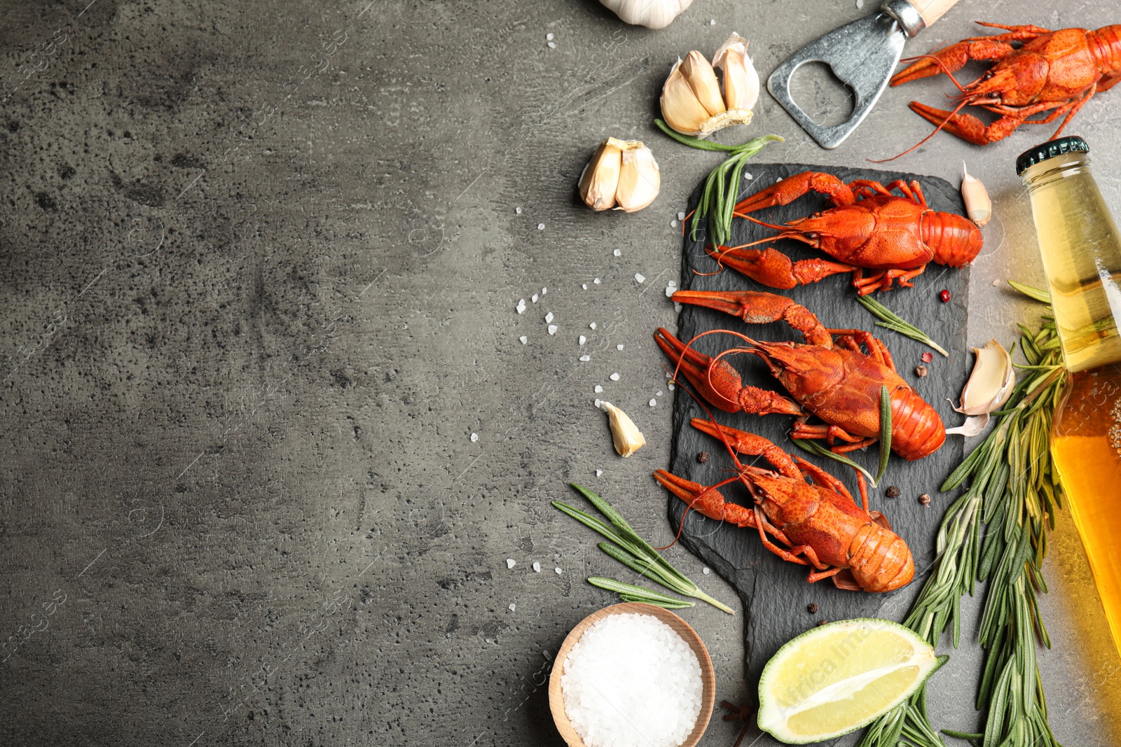 Photo of Flat lay composition with delicious red boiled crayfishes on black table. Space for text