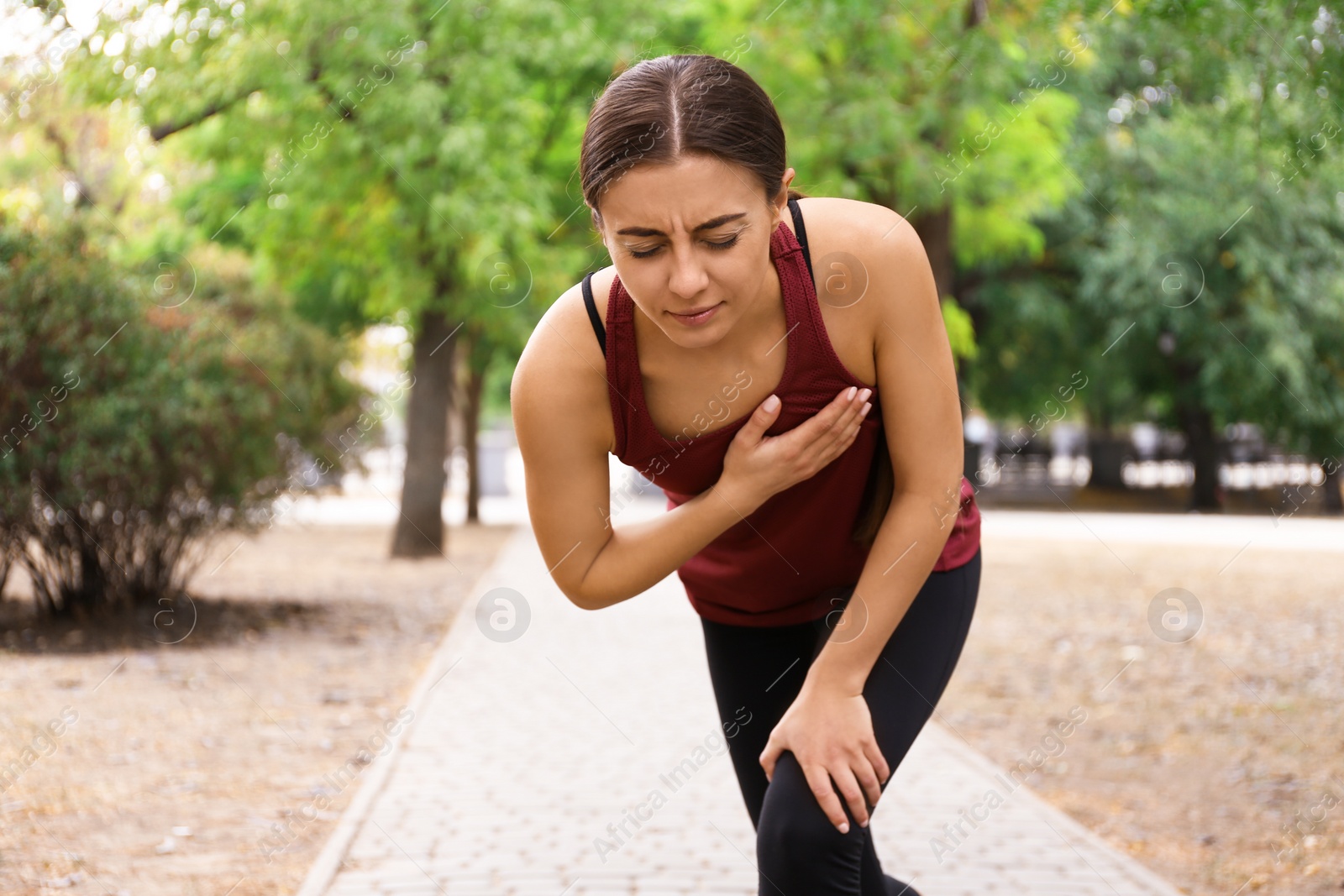 Photo of Young woman having heart attack while running in park