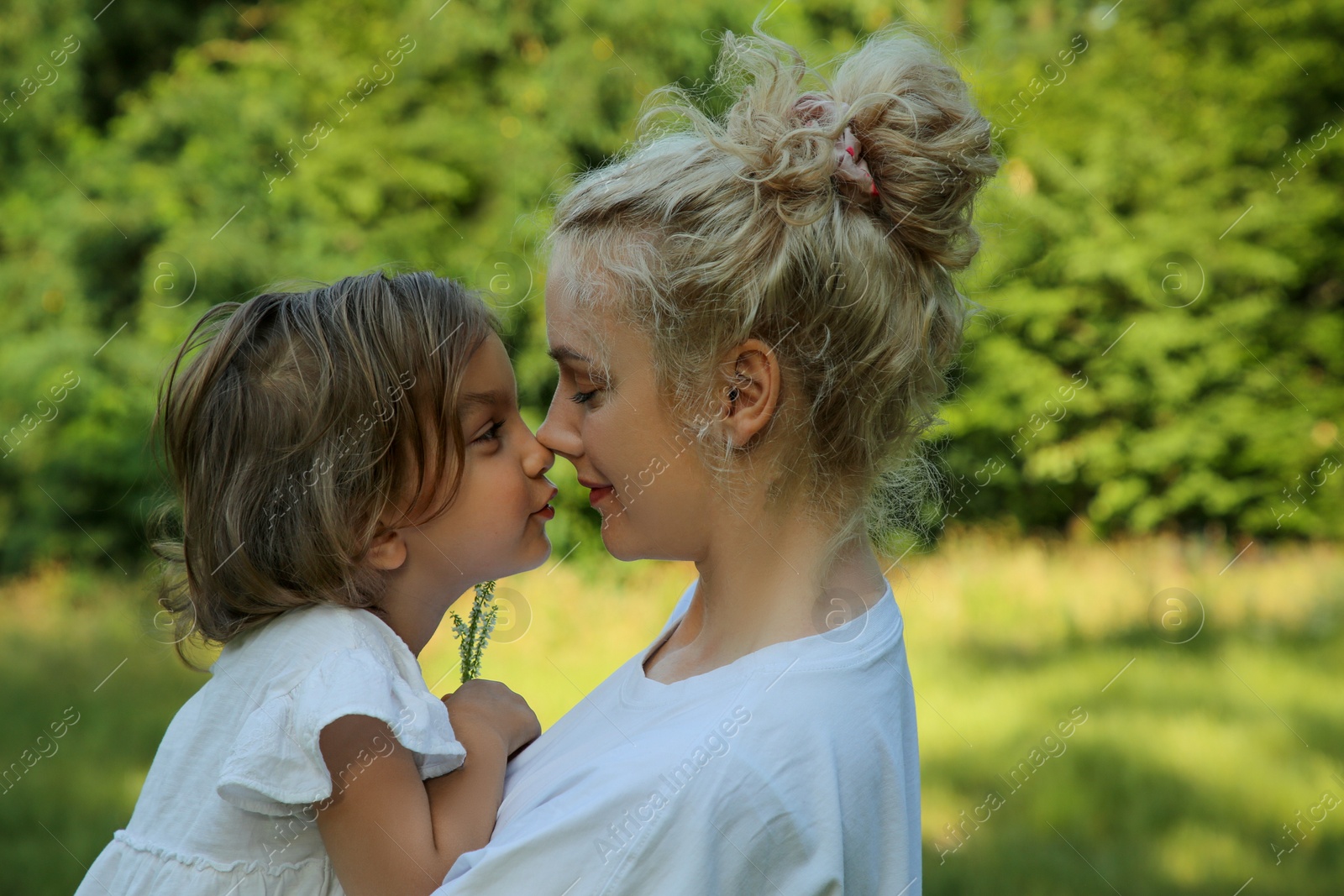 Photo of Portrait of beautiful mother with her cute daughter outdoors