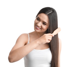 Photo of Beautiful young woman with hair brush on white background