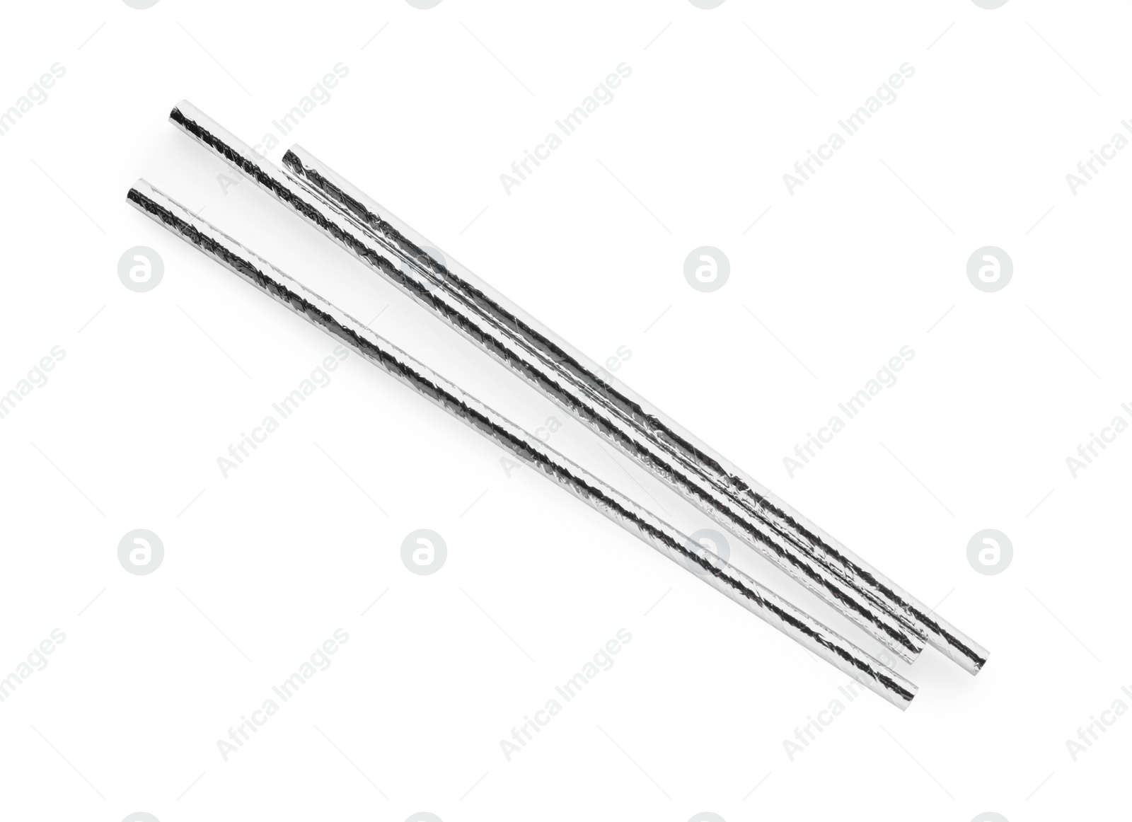 Photo of Silver plastic cocktail straws on white background, top view