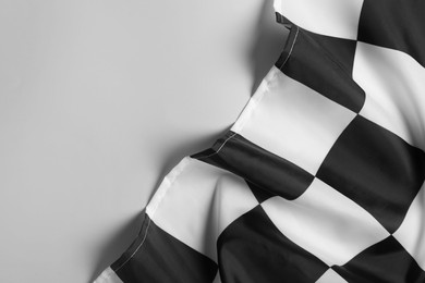 Checkered finish flag on white background, top view. Space for text
