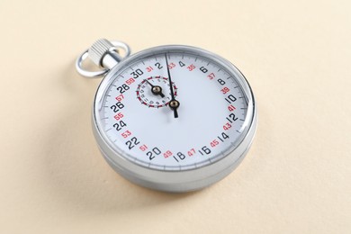 Photo of Vintage timer on beige background. Measuring tool