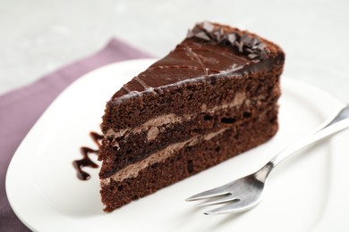 Piece of tasty chocolate cake served on plate