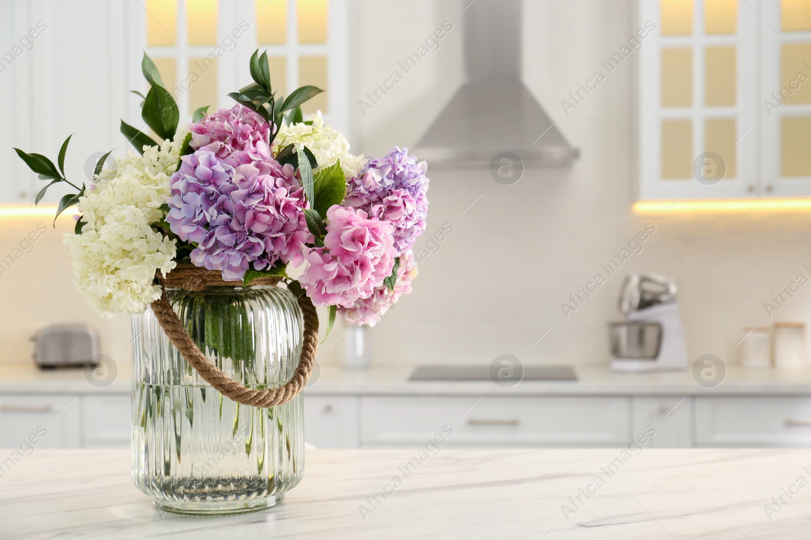 Photo of Bouquet with beautiful hydrangea flowers on white marble table. Space for text